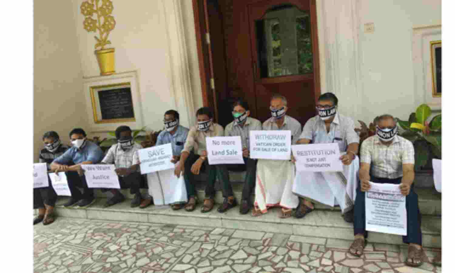 എറണാകുളം-അങ്കമാലി അതിരൂപതയിലെ ഭൂമി വില്‍പന: ബിഷപ്പ് ഹൗസിനു മുന്നില്‍  വായ്മൂടിക്കെട്ടി പ്രതിഷേധിച്ച് അല്‍മായ മുന്നേറ്റം